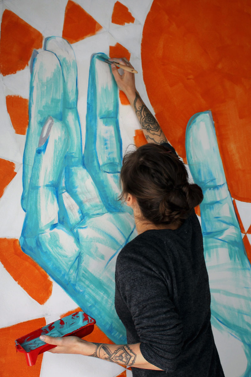 Melany Jane painting a mural in Woodstock, Cape Town, South Africa