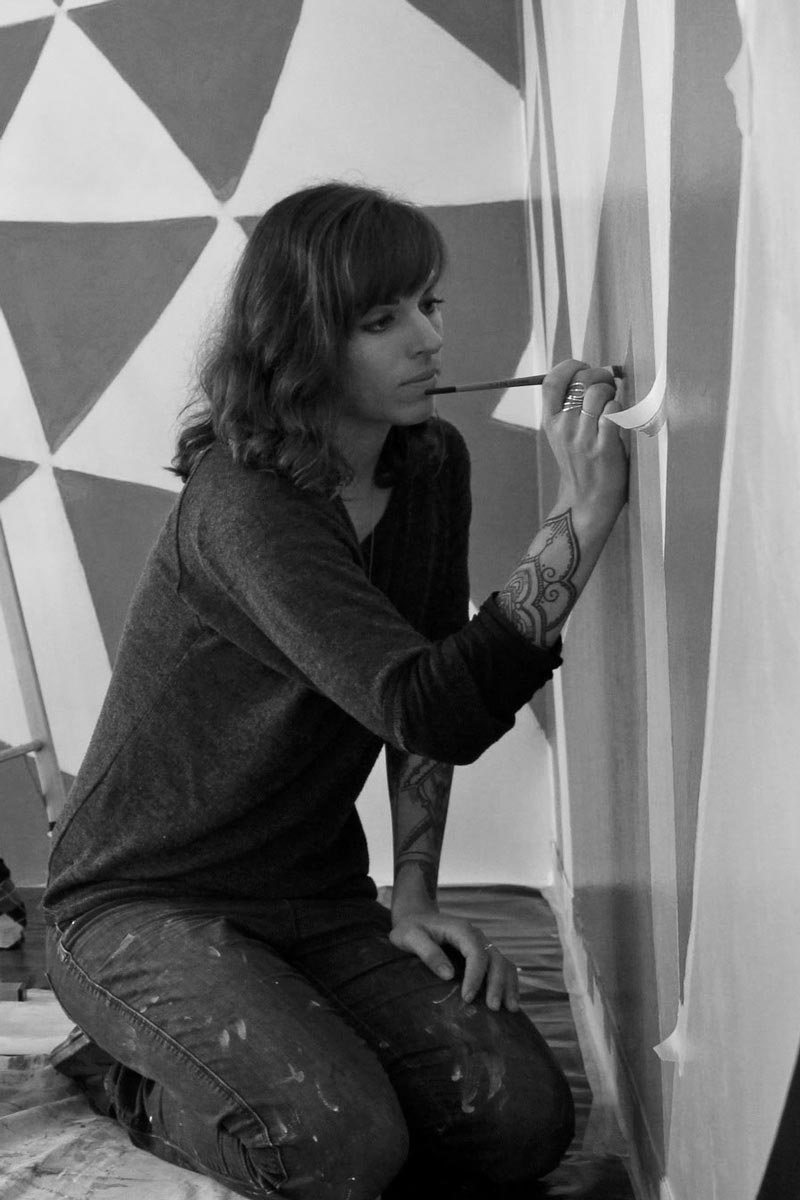 Melany Jane painting a mural in Woodstock, Cape Town, South Africa
